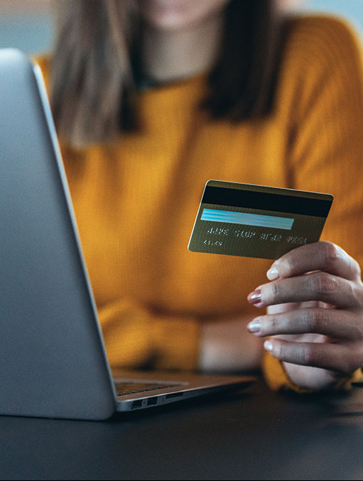 online-payment-women-holding-credit-card-at-computer